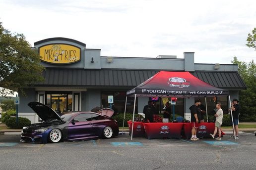 Custom printed red canopy tent at an outdoor car show