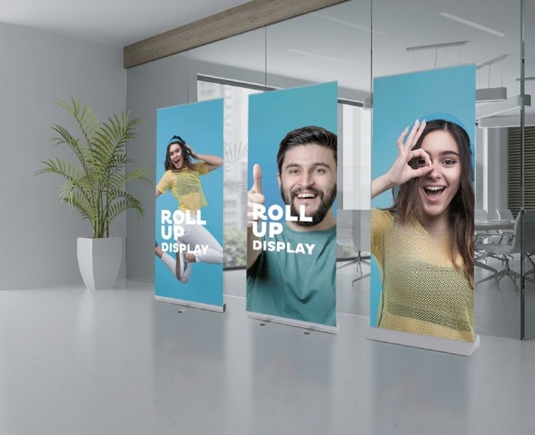 Retractable roll-up banner stands with full-color printed graphics in an office lobby