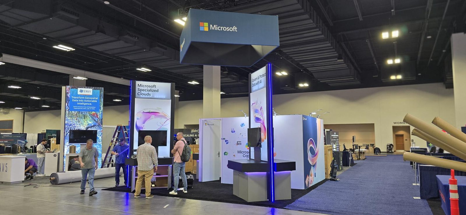 Wide view of a trade show floor featuring booth displays produced by Wholesale Print Direct